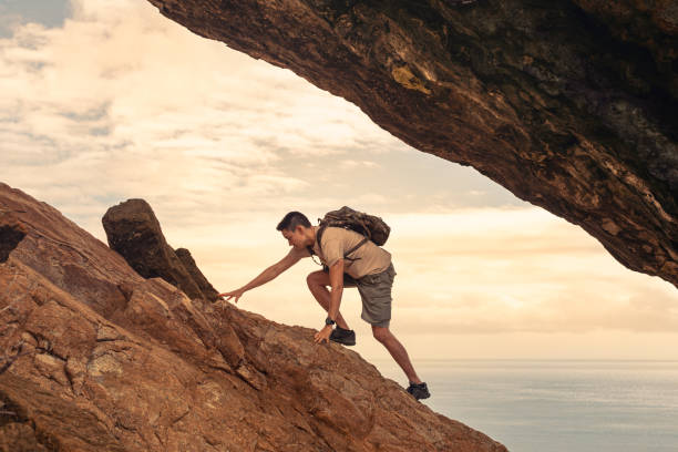 Hiker climbing up mountain.