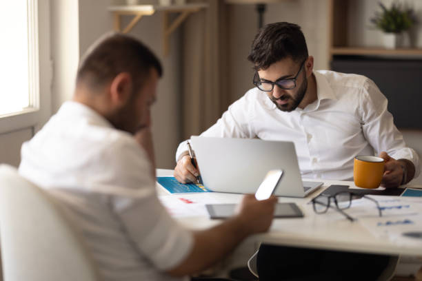 istock Two young businessmen discuss or plan project in office 2149734758