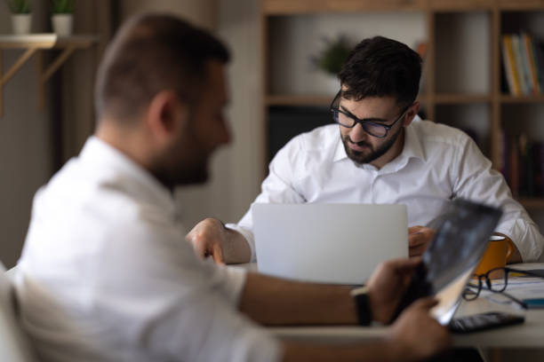 istock Two young businessmen discuss or plan project in office 2149734838
