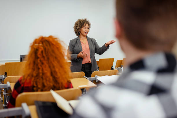 istock Female Professor Holding Lecture to a Group of Students 2149735607