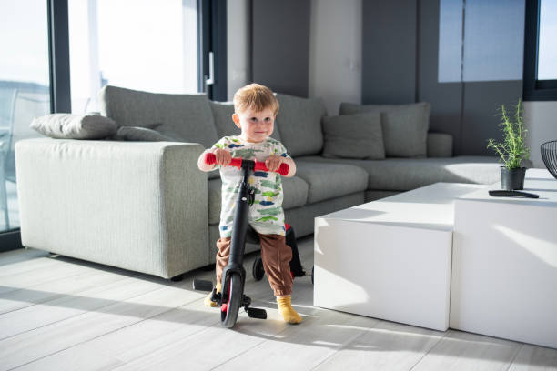 istock Little boy riding a bike inside at home. 2149736432