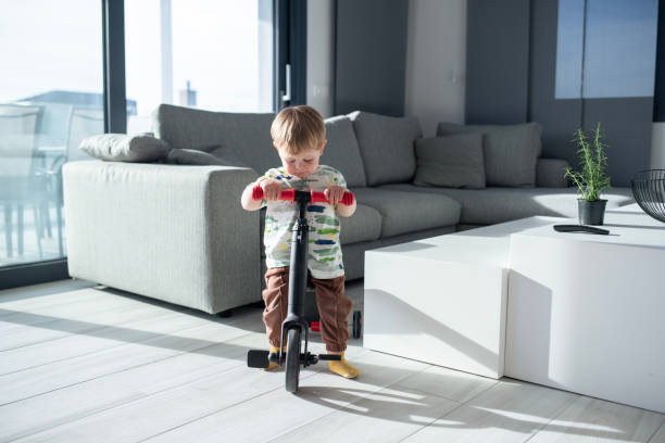 istock Little boy riding a bike inside at home. 2149736436