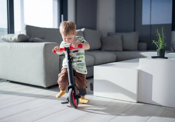 istock Boy playing with a bike at home. 2149736444