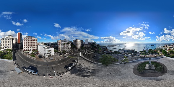 360 aerial photo taken with drone of Castro Alves monument and Cine Glauber Rocha, next to building covered in graffiti