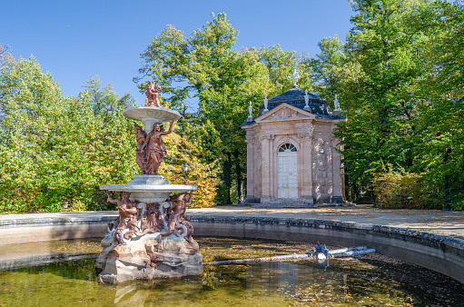 Real Sitio de San Ildefonso, Spain - October 13, 2019: Gardens in the French formal garden style with sculptural fountains at the Royal Palace of La Granja de San Ildefonso, an 18th-century palace in the town of San Ildefonso, Spain
