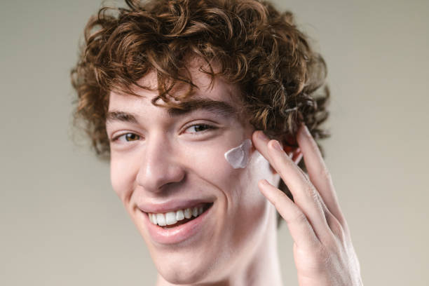 istock Portrait of a young man applying a face cream 2149737363