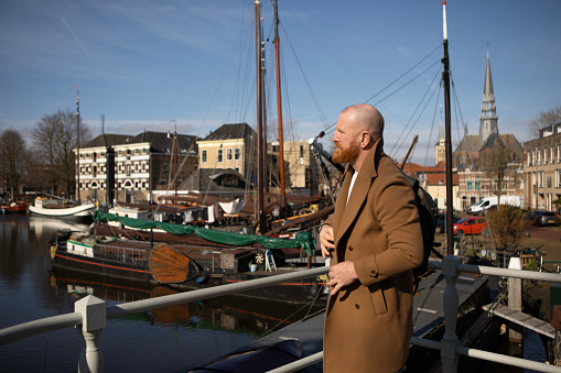 Redhead middle aged handsome male tourist travelling alone for male mental health wellness in Gouda, the Netherlands