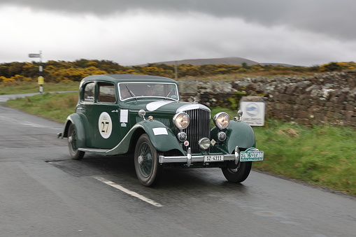 Caldbeck, England - April 13:  A 1934 Bentley 3.5L leaves Caldbeck, Cumbria on April 13, 2024.  The car is taking part in the Flying Scotsman Rally, a free public-event.