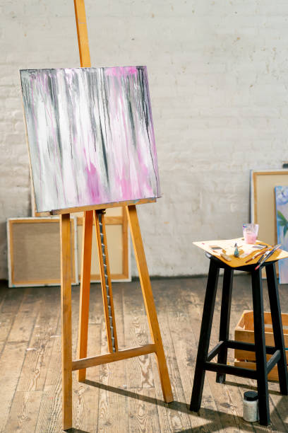 istock in the art workshop there is a tripod with a finished painting next to stool on which there is a palette and brushes 2149740621