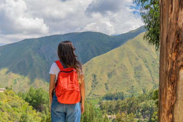 istock Young woman with a backpack on her back, looking at the horizon. 2149740746