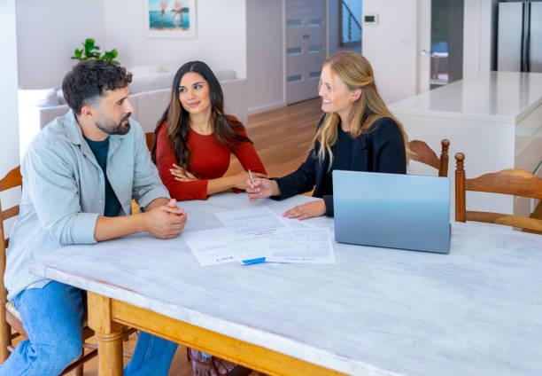 istock Real Estate or Insurance agent with couple looking through documents. 2149740769