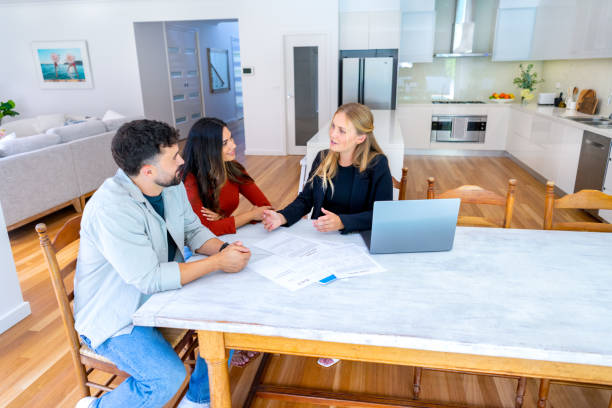 istock Real Estate or Insurance agent with couple looking through documents 2149740796