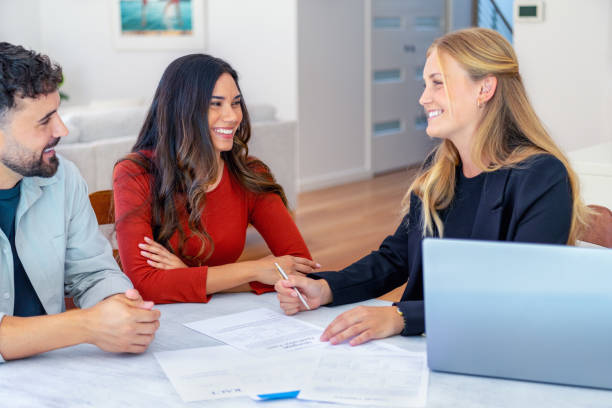 istock Real Estate or Insurance agent with couple looking through documents. 2149740818