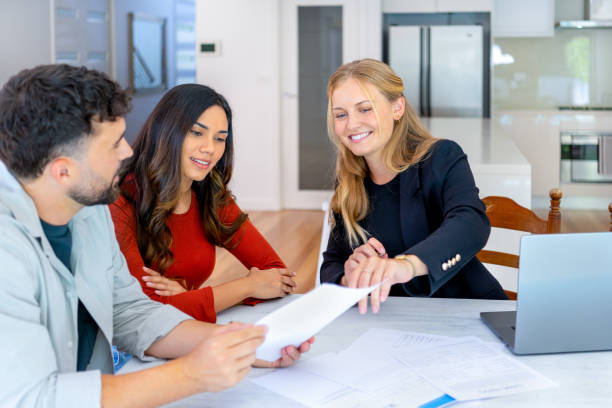 istock Real Estate or Insurance agent with couple looking through documents. 2149740827