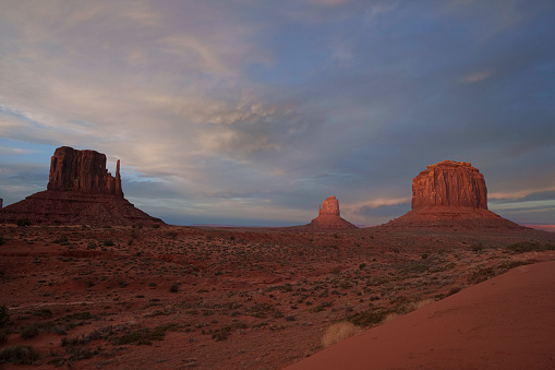 East and West Mittens and Merrick Butte in Monument Valley Tribal Park Utah Under a Dramatic Sunset Sky in Late Springtime