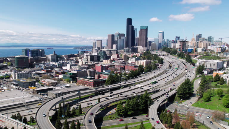 Drone Flying Over Freeway to Seattle Skyline Buildings