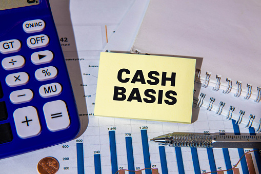 Cash Basis is shown using a text and photo of calculator.