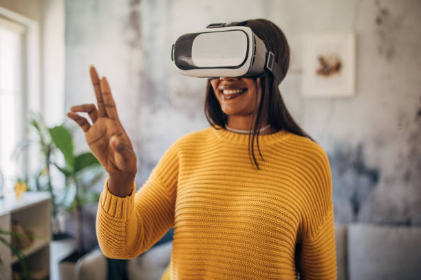 Woman in VR headset making peace sign