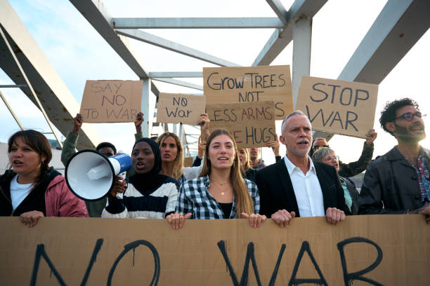 istock Multiracial woman with megaphone in protest with diverse group activist people demonstrate together. 2149743042