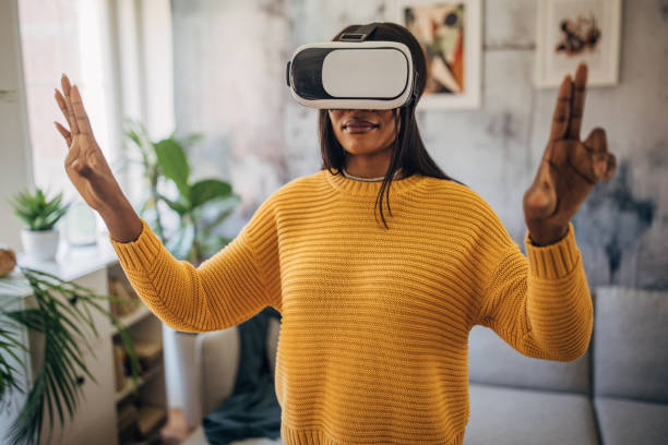 istock Woman experiencing virtual reality at home 2149744491