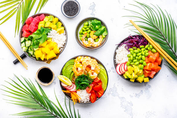 istock Poke bowls with vegetables and seafood set for balanced diet, white table background, top view 2149745599