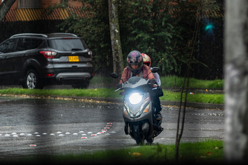 Bogota, Colombia., 18 de Abril de 2024:Driving a motorcycle in the rain on the road