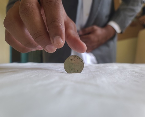 Limited resources: middle-class man takes a quarter dollar before his job interview