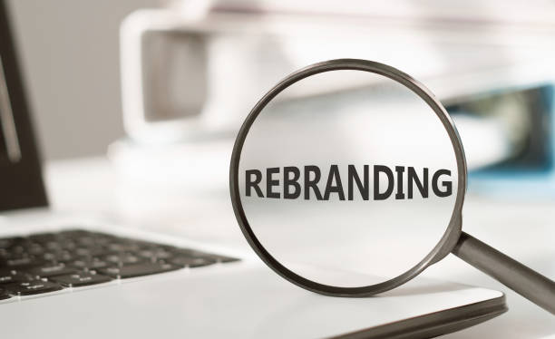 istock Word rebranding on office through magnifying glass. 2149746933