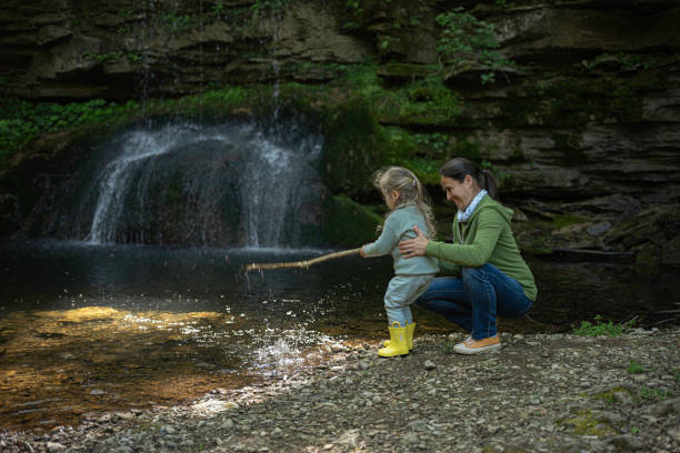 istock Family Day. Mom & Kid at River in Spring. 2149747245