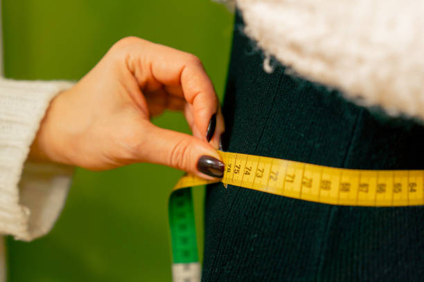 istock close-up in a sewing workshop seamstress takes measurements from a model 2149747627