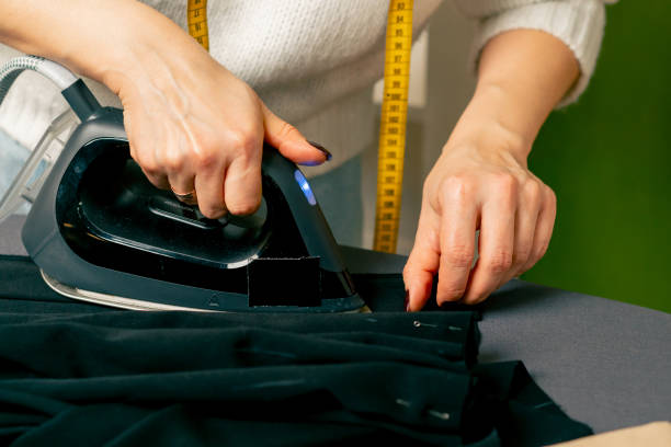 istock close up in a sewing workshop seamstress in wight irons black fabric for corrugation 2149747751