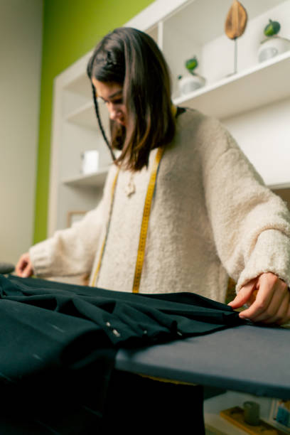 istock in a sewing workshop seamstress folds black fabric for corrugation 2149748284