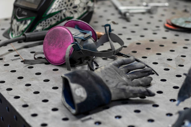 Female welder working on a personal project at a metal shop