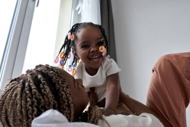istock laughing happy little adorable kid on her mom's hands looking at camera 2149751315