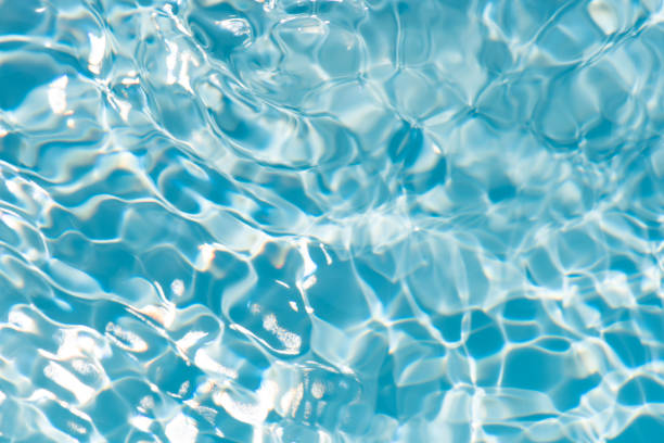 istock Bluewater waves on the surface ripples blurred. Defocus blurred transparent blue colored clear calm water surface texture with splash and bubbles. Water waves with shining pattern texture background. 2149753074