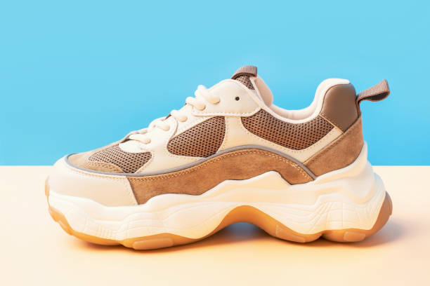 istock Stylish sneakers on a brown and blue background, close-up side view. 2149757076