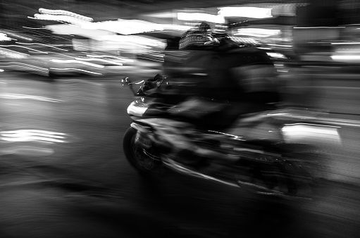 Biker at full speed, motion blur at night.