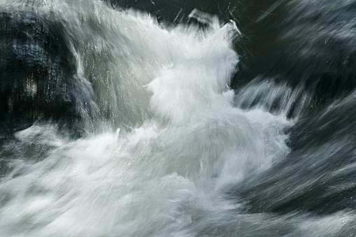 River tumbling between boulders at slow shutter speed -- the Bantam River in Washington, Connecticut