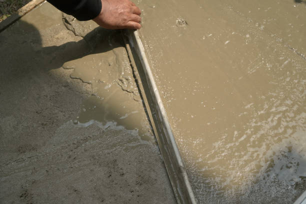 istock Hand worker spreading flattening on plaster cement mortar. 2149758388