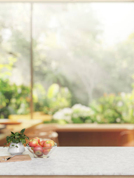 istock A marble white kitchen tabletop with a blurred background of a garden. 2149758876