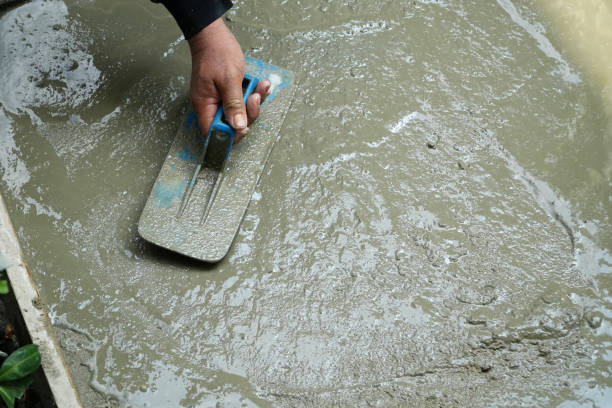 istock Hand worker holding trowel for smoothing plaster concrete floor. 2149759200