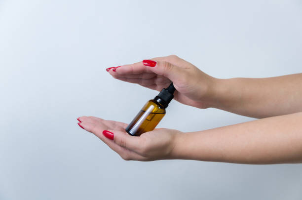 istock Product package with serum and a woman hand in studio 2149759548