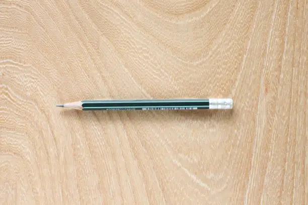 a pencil isolated and wooden background