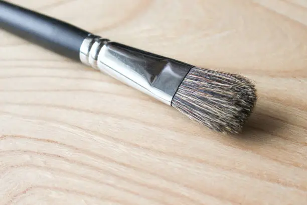 a drawing brush isolated and wooden background
