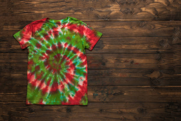 istock A dyed tie dye T-shirt on a dark brown background. 2149761521