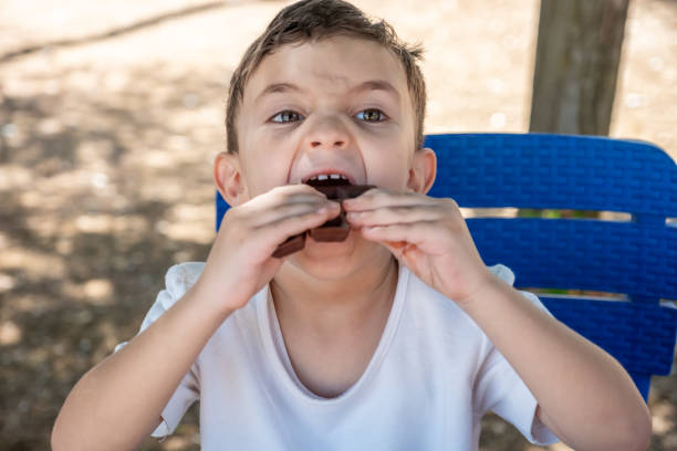 Close up view of child eating ice cream. Health concept background. Sweden.