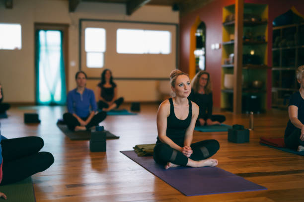 istock Group of women sit on mats during yoga class 2149765227