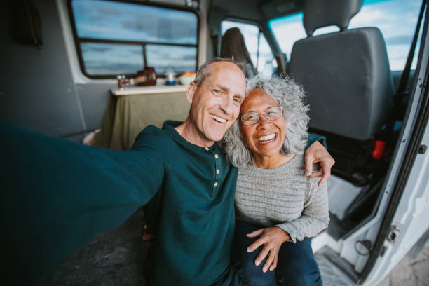 istock Multiracial senior couple take a selfie while sitting in camper van 2149766488