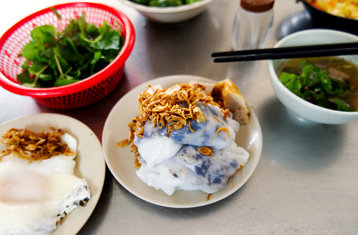 Banh cuon, a Vietnamese steamed rice roll dish at street food stall. A popular breakfast street food dish in Vietnam