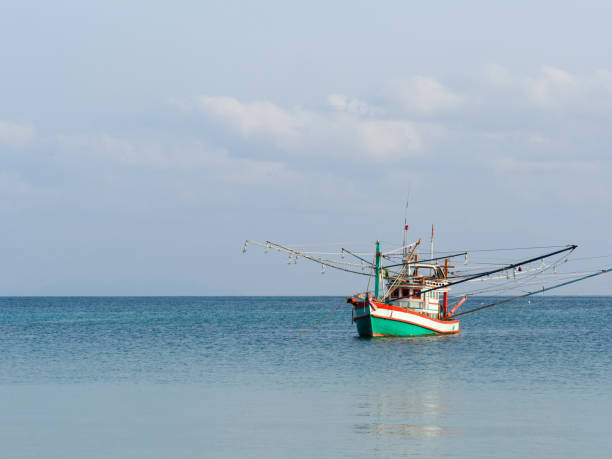 istock Fishing boat anchored against a clear sky 2149767712